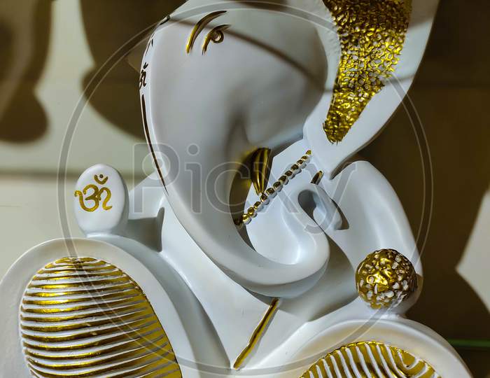 Beautiful Artistic Figurine Of God Ganesha In Gold And White.