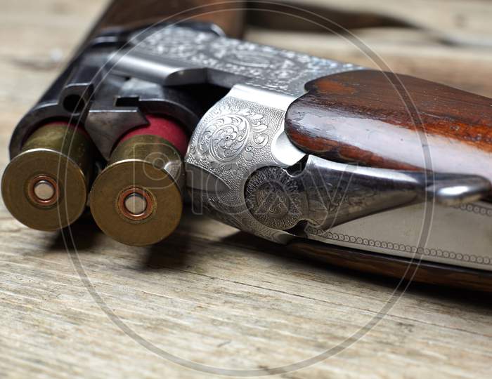 Vintage Hunting Gun With Cartridges On Wooden Background