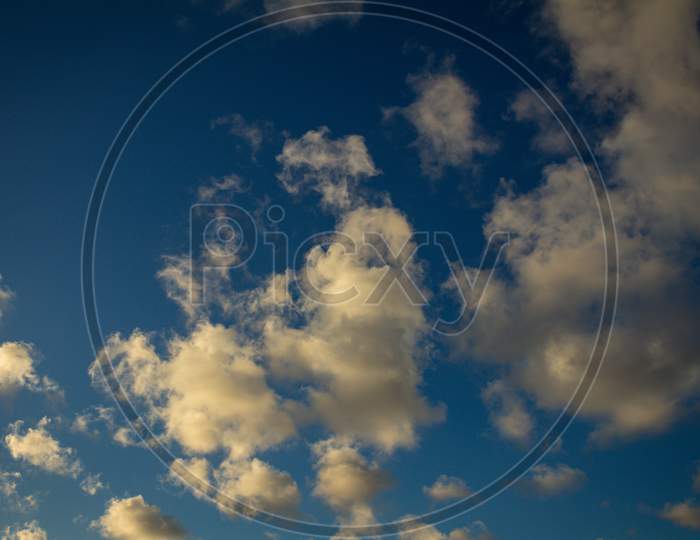Striking Fluffy Clouds In The Blue Sky. Background For Designers.
