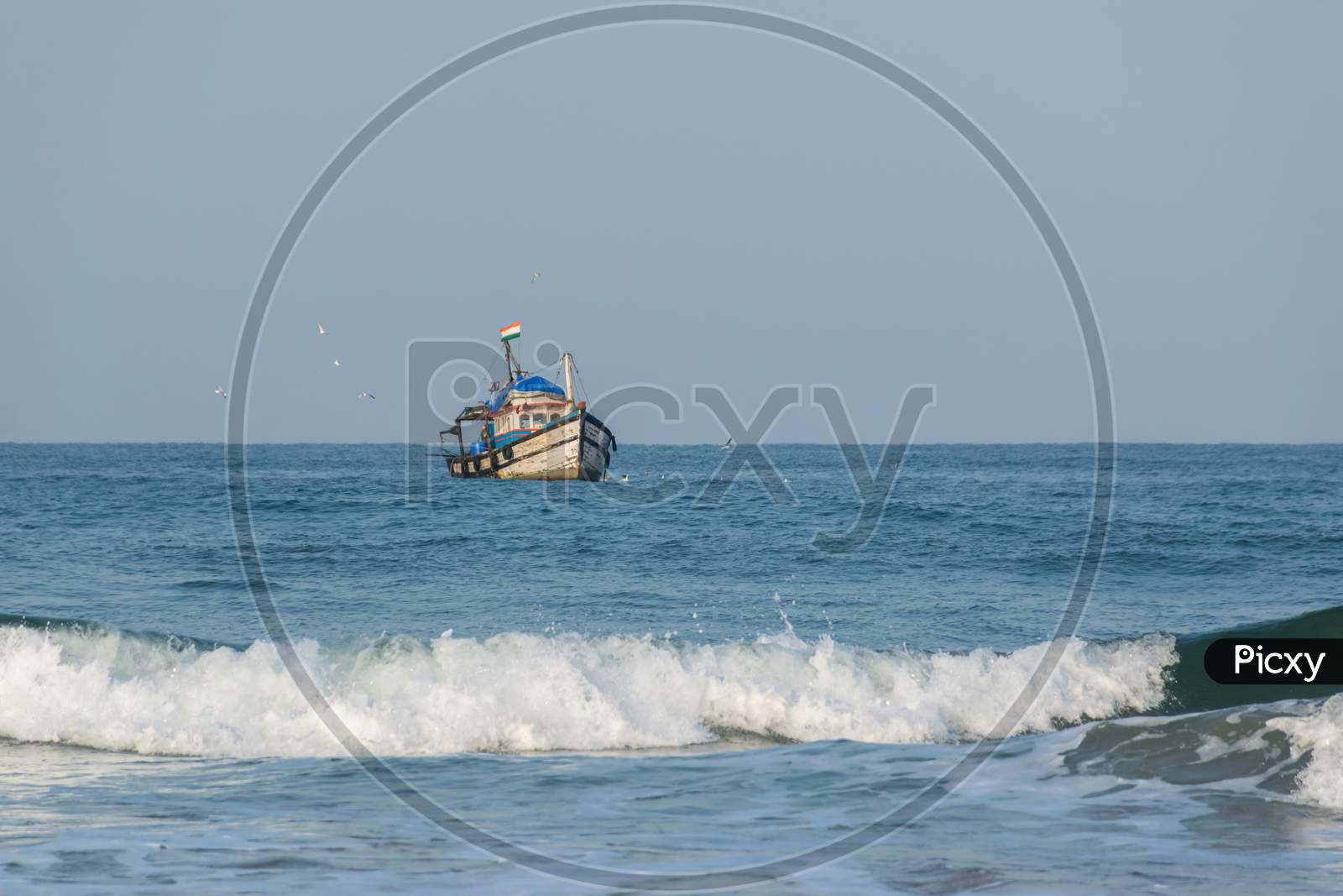 A Fishing Boat Sailing Towards The Coast Of Arabian Sea In Goa, India