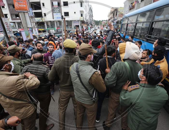 Policemen stops National Conference supporters from marching towards main road after Bjym activists made an unsuccessful attempt to stage a protest outside former chief minister Farooq Abdullah's residence in Jammu on Wednesday. The bjym activists were protesting against alleged encroachment of land