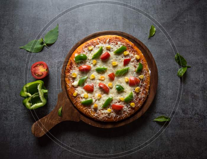 Top view of Italian food pizza with vegetables and herbs