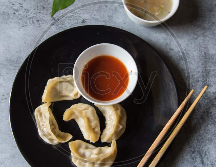 Tibetan delicacy dumplings in a plate along with condiments