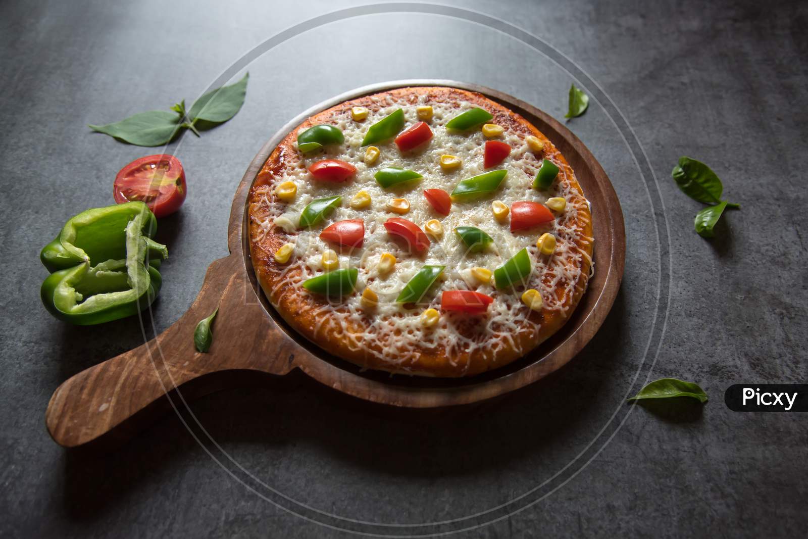 Close up of margherita cheese  pizza with bell peppers tomatoes and basil