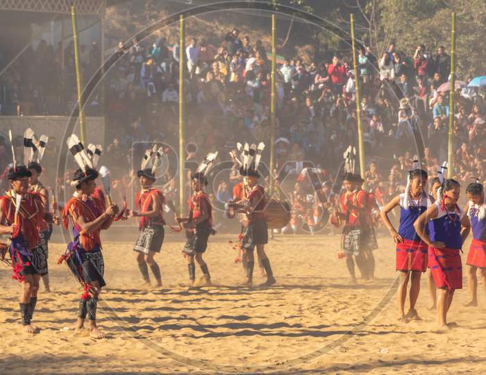 Group of naga tribesmen and women dressed in their traditional attire dancing