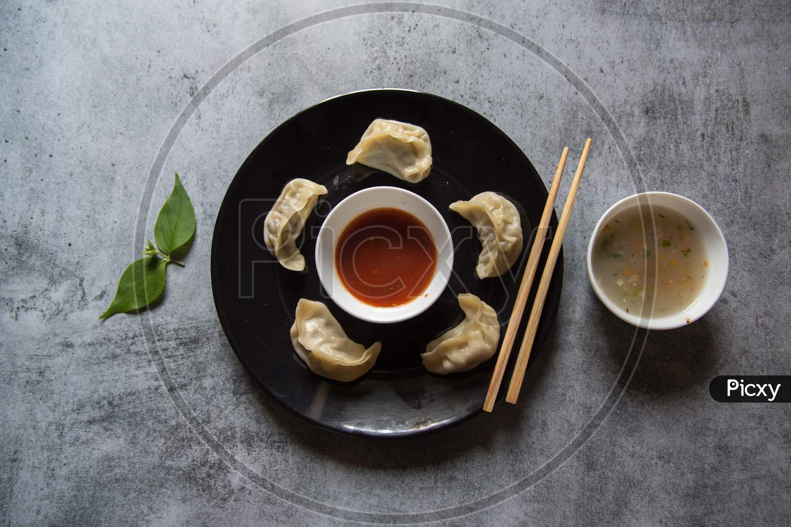 Popular snacks of south east Asia momos on a black plate