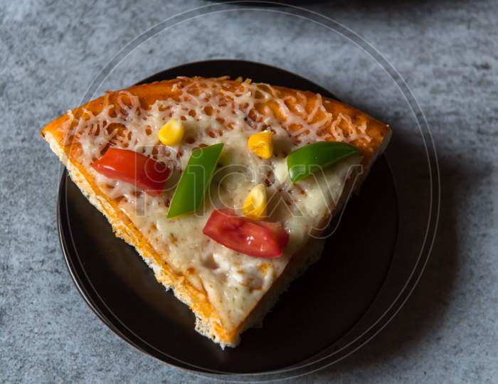 Top view of a slice of pizza on a plate.