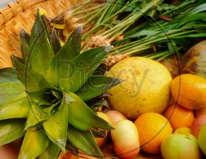 Fruits like pineapple, orange, Apple, e.t.c in a basket