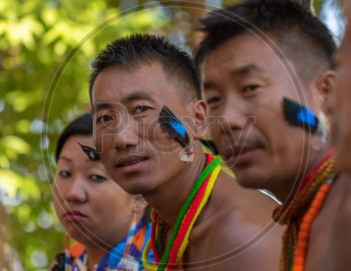 Naga people wearing traditional blue feathers on them
