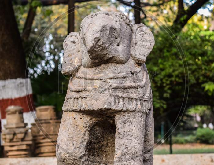 An Old Broken Elephant Trunk Statue Made Of Rock Amongst Of Tree In Kolhapur City , Maharashtra.