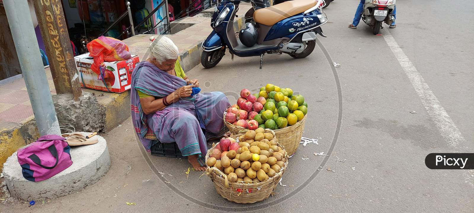 An old woman selling fruits at Roadside in vijayawada