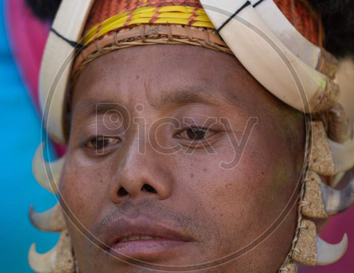 Portrait of a tribal Naga tribseman dressed in traditional attire and head gear