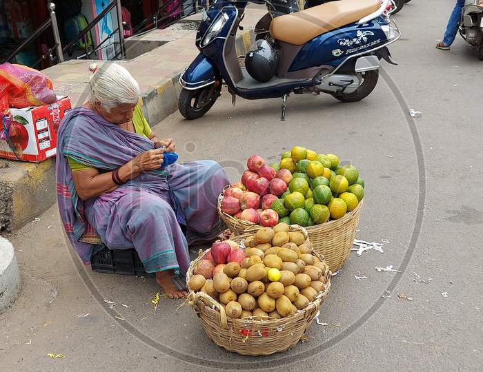 An old woman selling fruits at Roadside in vijayawada