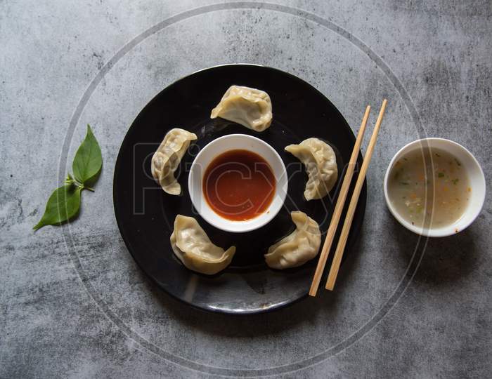 Popular snacks of south east Asia momos on a black plate