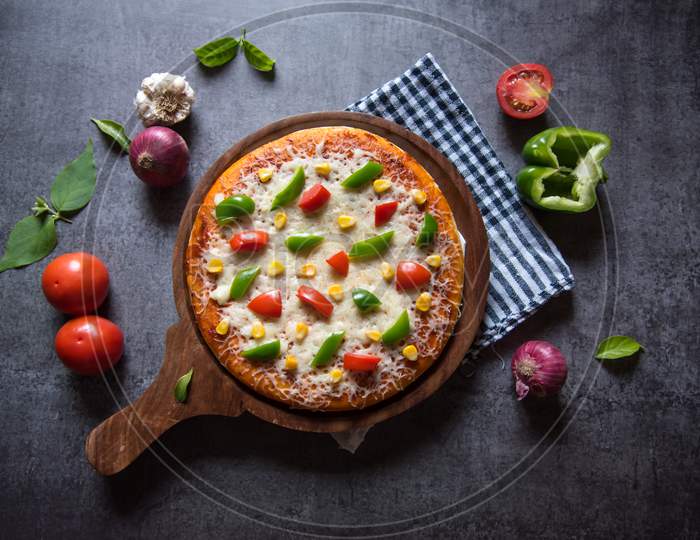 View directly from above of Italian delicacy pizza with capsicum tomatoes and cheese