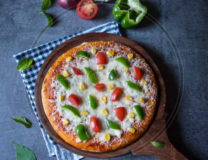 Vertical view of popular delicacy pizza with tomatoes and mozzarella