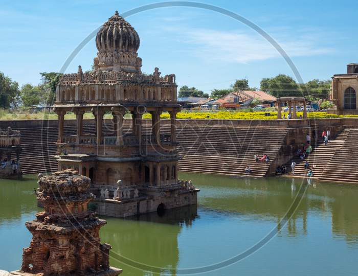 An Engaging view of an Ancient Rama Temple built in the middle of a Sacred Waterpond or Pushkarni with geometrically arranged  granite steps built in 16th Century at Santhebennur in Karnataka/India.