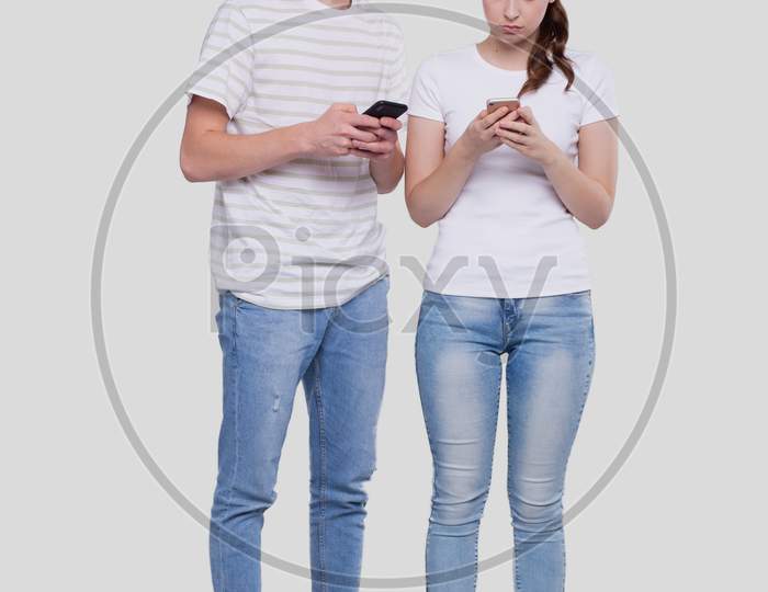 Couple Chatting On Phone. Couple Using Phones Standing Isolated. Couple Shopping Online.