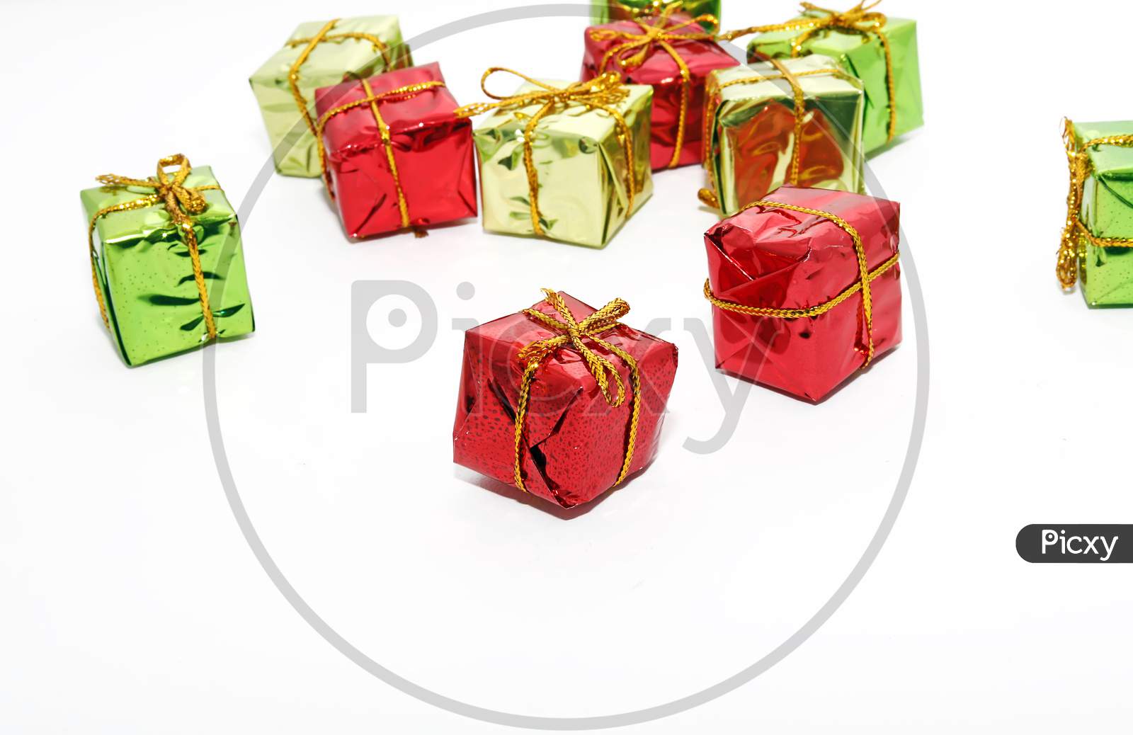 Top View Of Arranged Wrapped Christmas Gift Boxes With Ribbons On White Background