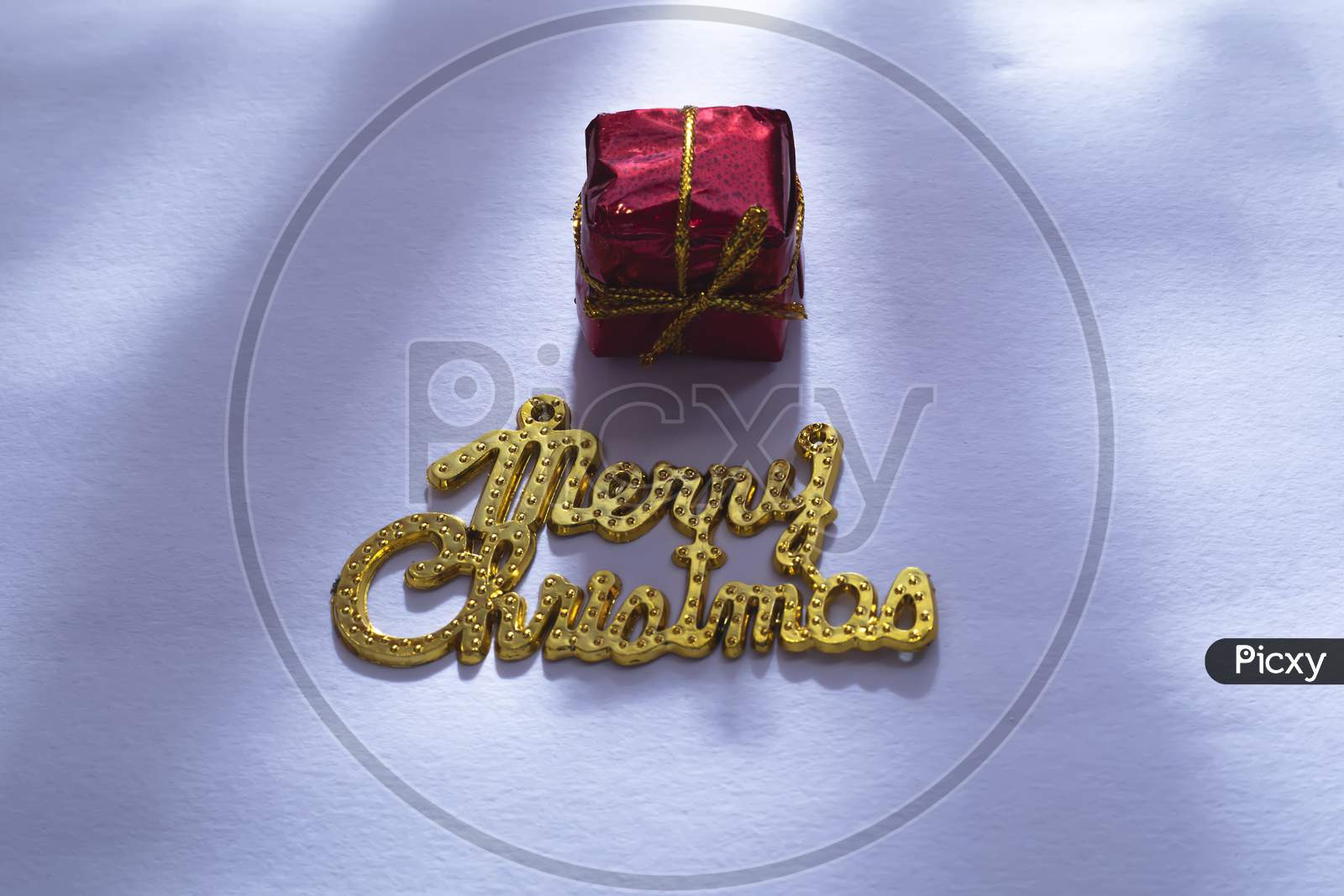 Merry Christmas Gold Text With Gift Box Isolated On White Background Or Snow Background
