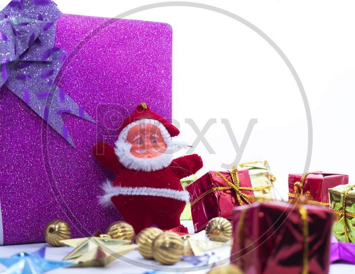 Christmas Decoration. Santa Claus With The Large Gift Box Is Isolated On A White Background