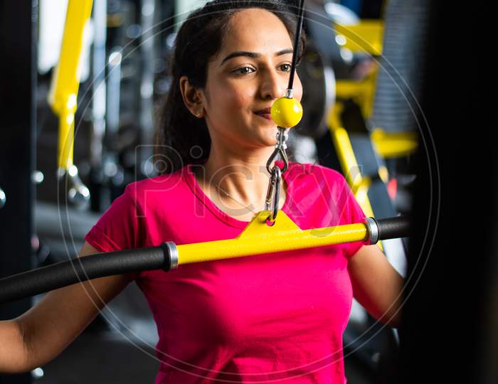 Indian Asian Young Girl Exercising Or Working Out In The Gym