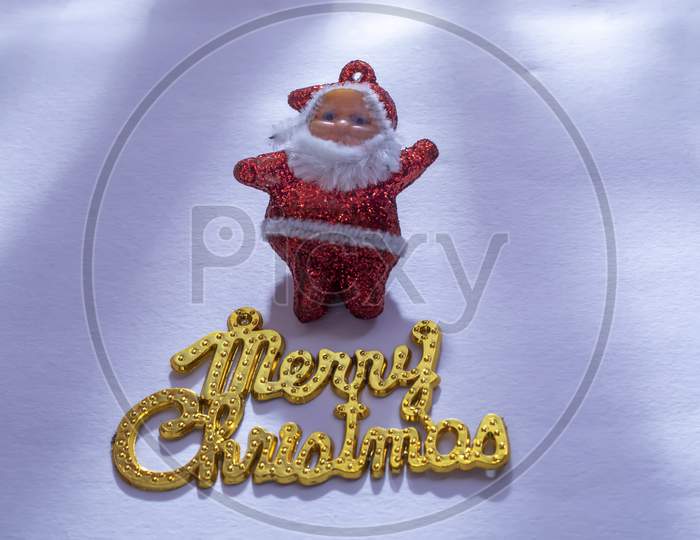 Santa Claus With A Merry Christmas Gold Text Is Isolated On A White Background Or Snow Background