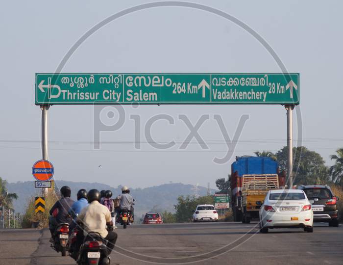 Thrissur, Kerala, India - 11-28-2020: Sign Board On The Highway To Thrissur, Salem, Vadakkenchery