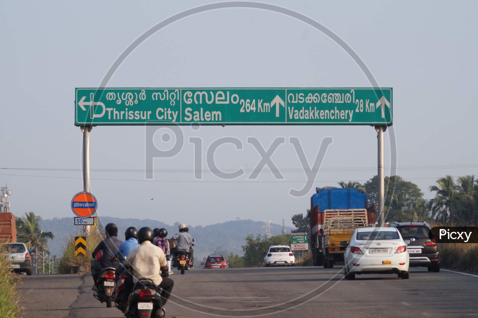 Thrissur, Kerala, India - 11-28-2020: Sign Board On The Highway To Thrissur, Salem, Vadakkenchery