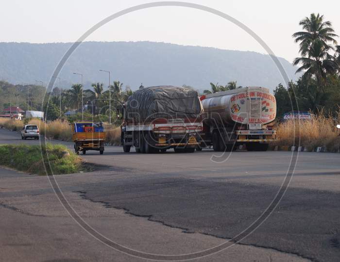 Thrissur, Kerala, India - 11-28-2020: Loaded Vehicles Passing Through The National Highway. Truck, Tanker And Auto Rickshaw