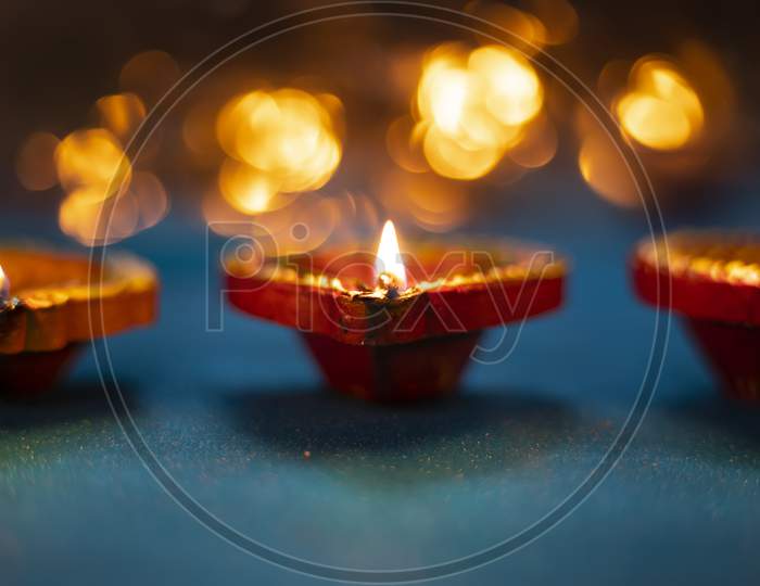 Happy Diwali - Colorful Clay Diya Lamps Lit During Diwali Celebration With Glittering Bokeh