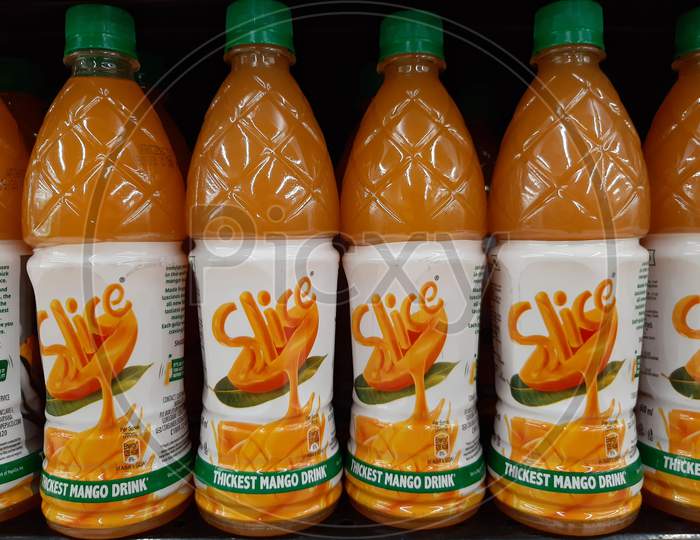 kochi, India - 23 April 2021 : Bottles of slice mango drink in supermarket