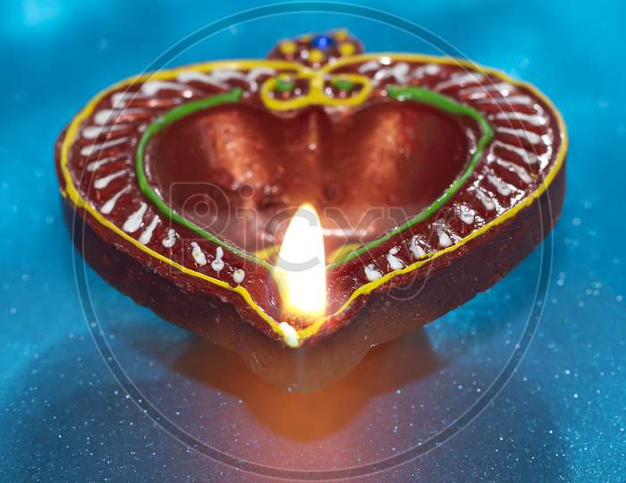 Diya Lamps On A Reflective Base With Glittering Bokeh