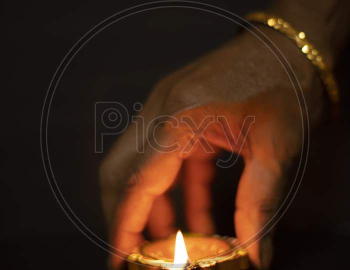 Happy Diwali - Hand Holding Or Lighting Or Arranging Diwali Diya Or Clay Lamp In Dark Background, Selective Focus
