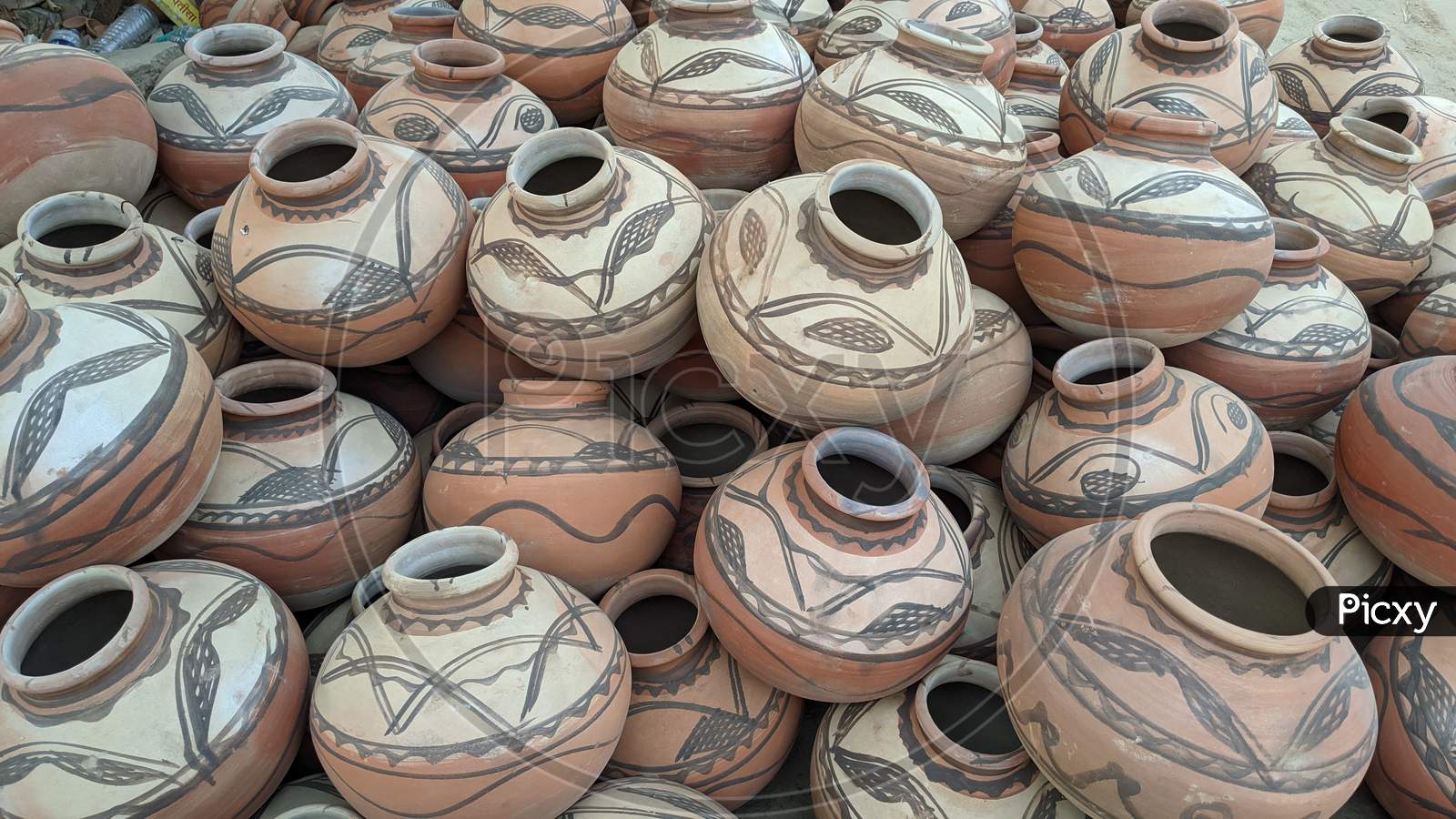 Great Indian festival of Diwali season. Clay lamps and earthen pots on a footpath to sell Reengus, Indian clay pot in market outdoor