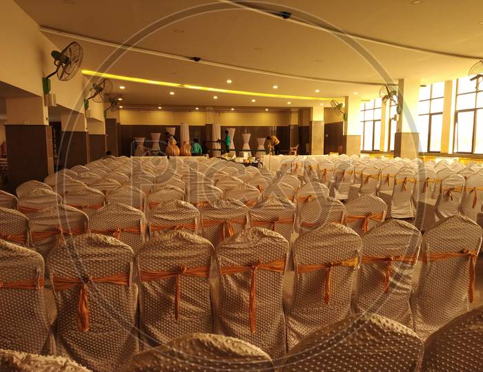 Empty marriage hall with empty decorated chairs