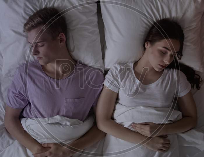 Couple Sleeping In Bed. Couple In Bed At Night Time. Couple In Bed. Shot On Red