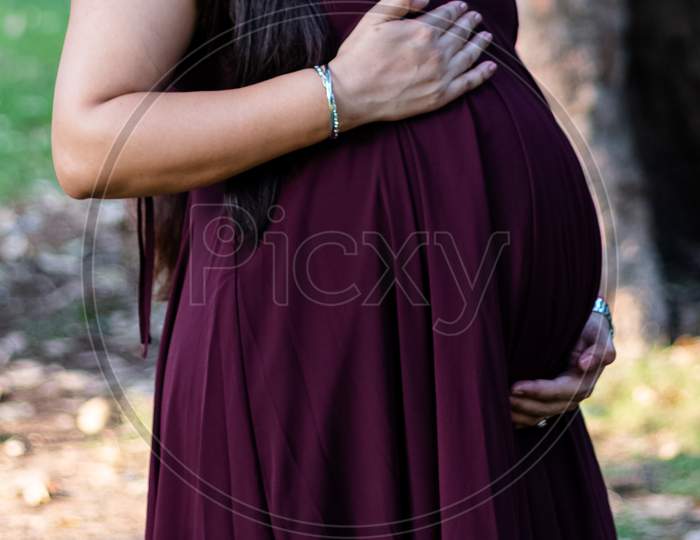 Indian Pregnant woman touching her belly
