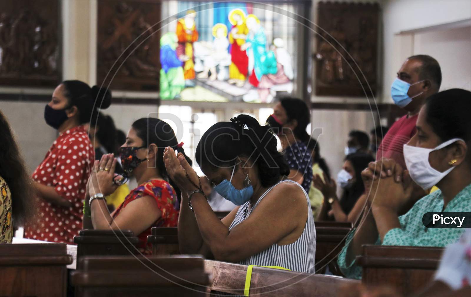 Devotees wearing protective masks attend Sunday mass at a church amid the spread of the coronavirus disease (COVID-19) in Mumbai, India, November 29, 2020.