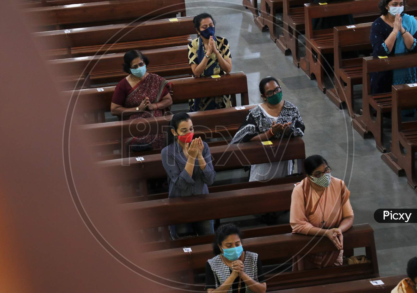 Devotees wearing protective masks attend Sunday mass at a church amid the spread of the coronavirus disease (COVID-19) in Mumbai, India, November 29, 2020.