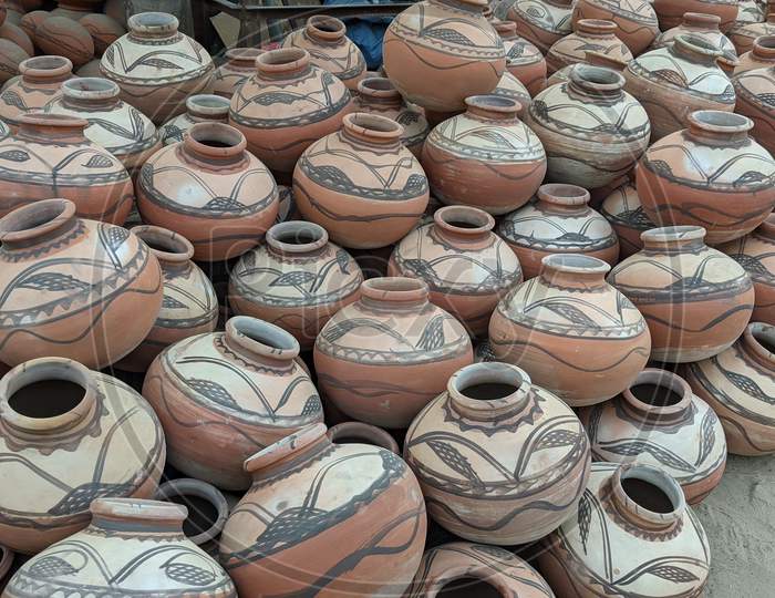Great Indian festival of Diwali season. Clay lamps and earthen pots on a footpath to sell Reengus, Indian clay pot in market outdoor