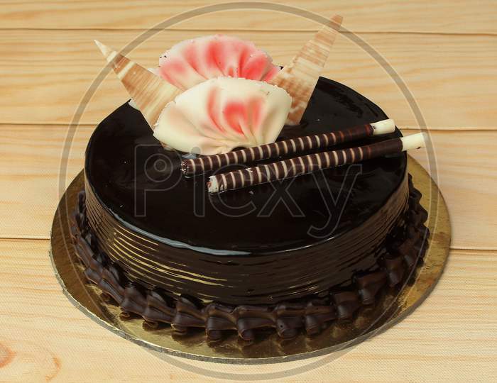 Freshly Made Swiss Chocolate Cream Cake On Wooden Table. Selective Focus