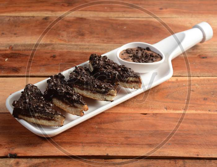 Toasted Bread Slices With Chocolate Cream On White Plate