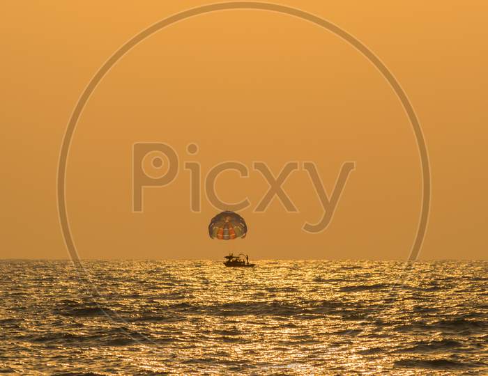 A Parasailing Boat In Arabian Sea At Sunset Near Baga Beach, Goa, India