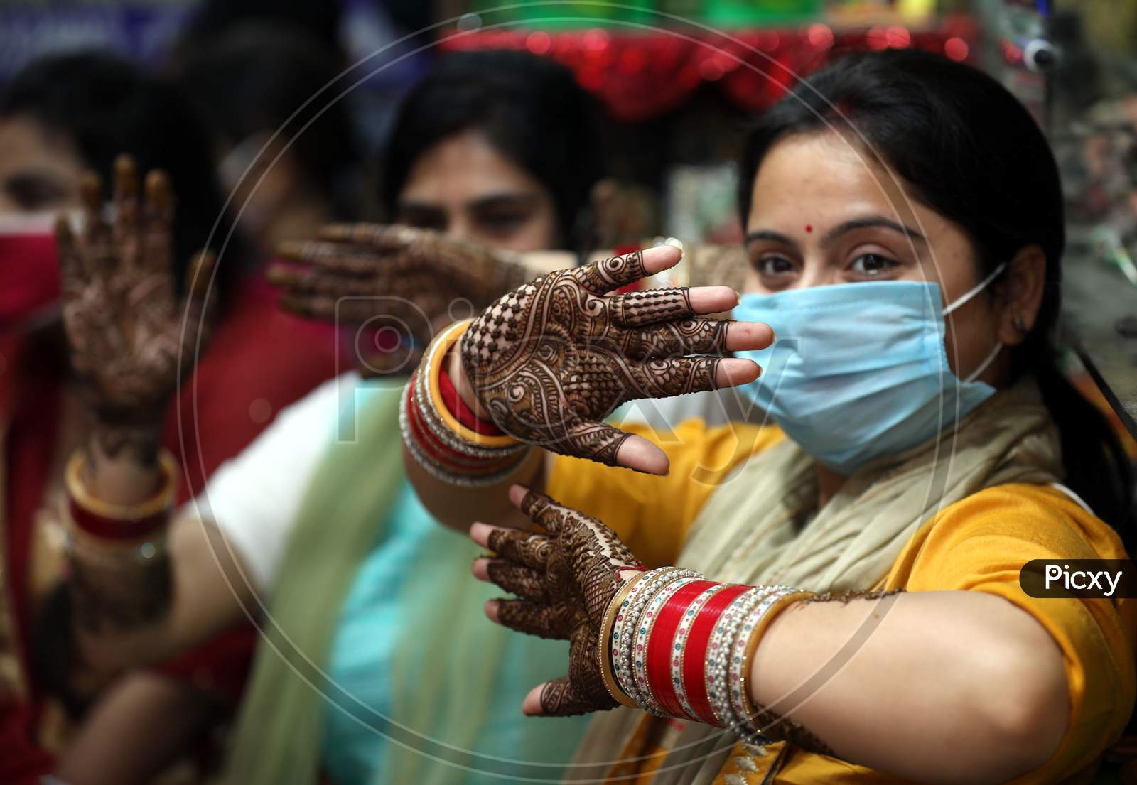 Woman showing hands decorated with 'Mehndi' or Henna on the eve of the Karwa Chauth festival in Jammu ,3 November.2020.