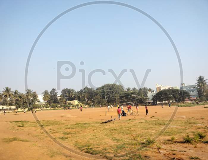 A very big open playground with chindren playing