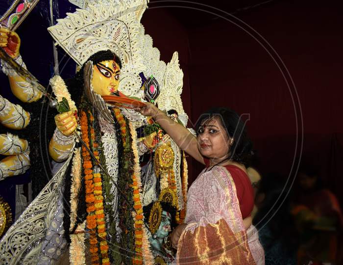 Bengali woman performing rituals during Durga Puja