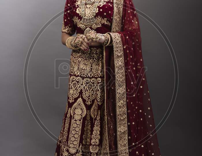 Young Indian lady in ethnic bridal wear, jewelry and make-up