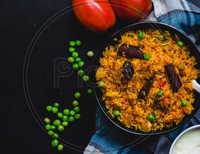 Delicious Indian Pulao or Rice full of spices in flat lay to stay healthy and menu