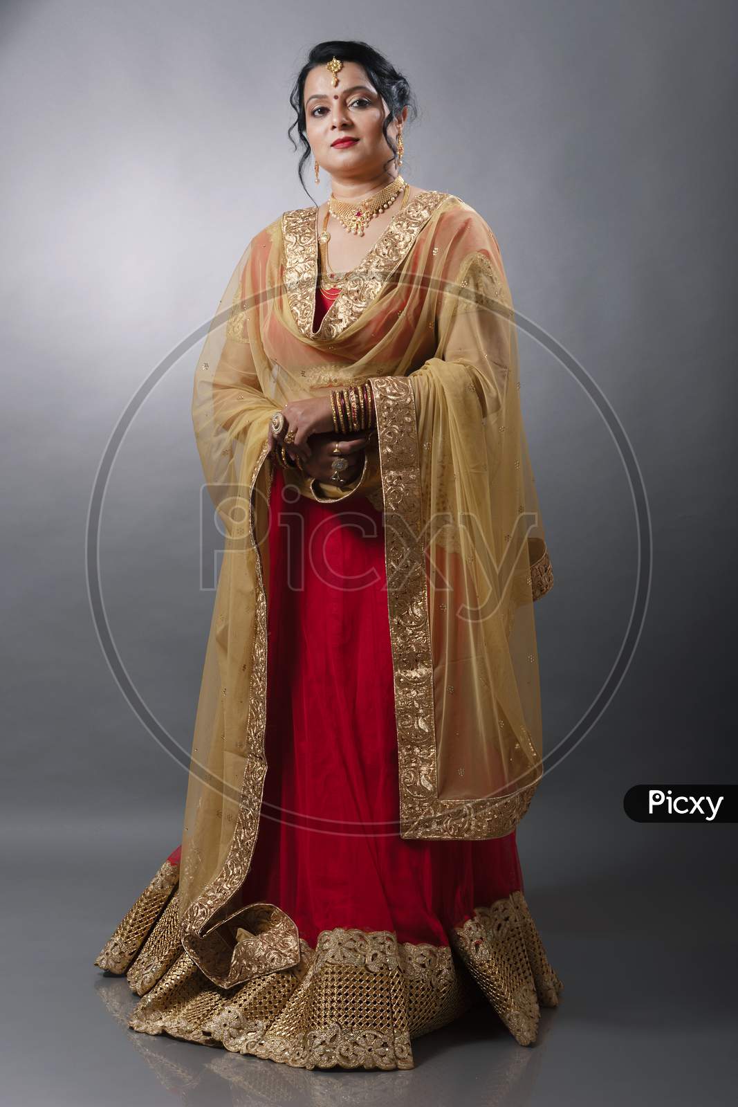 Middle aged Indian woman wearing traditional designer wear